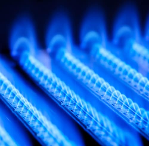 Blue flames of a gas burner inside a boiler