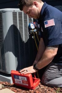 Air conditioner, NATE Certified HVAC service technician, Air conditioning service technician checking coolant levels.