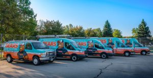 A fleet of five Bears Home Solutions HVAC service vans in a parking lot.
