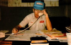 An old photo of Custom Aire and Bears Home Solutions founder, Dale Boettner, on the phone at his desk.