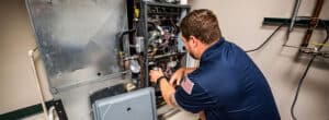 A Bears Home Solutions technician working on a furnace