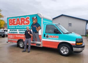 Plumber from Bears Home Solutions poses in front of his vehicle.