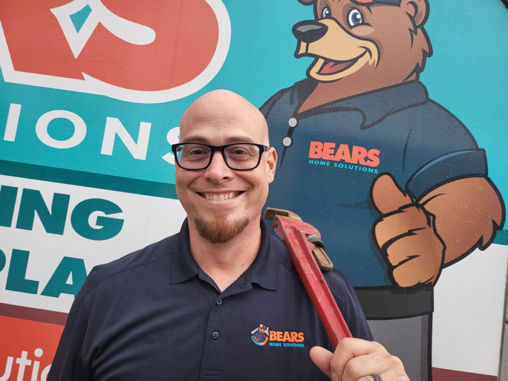 Plumber from Bears Home Solutions poses in front of his vehicle.