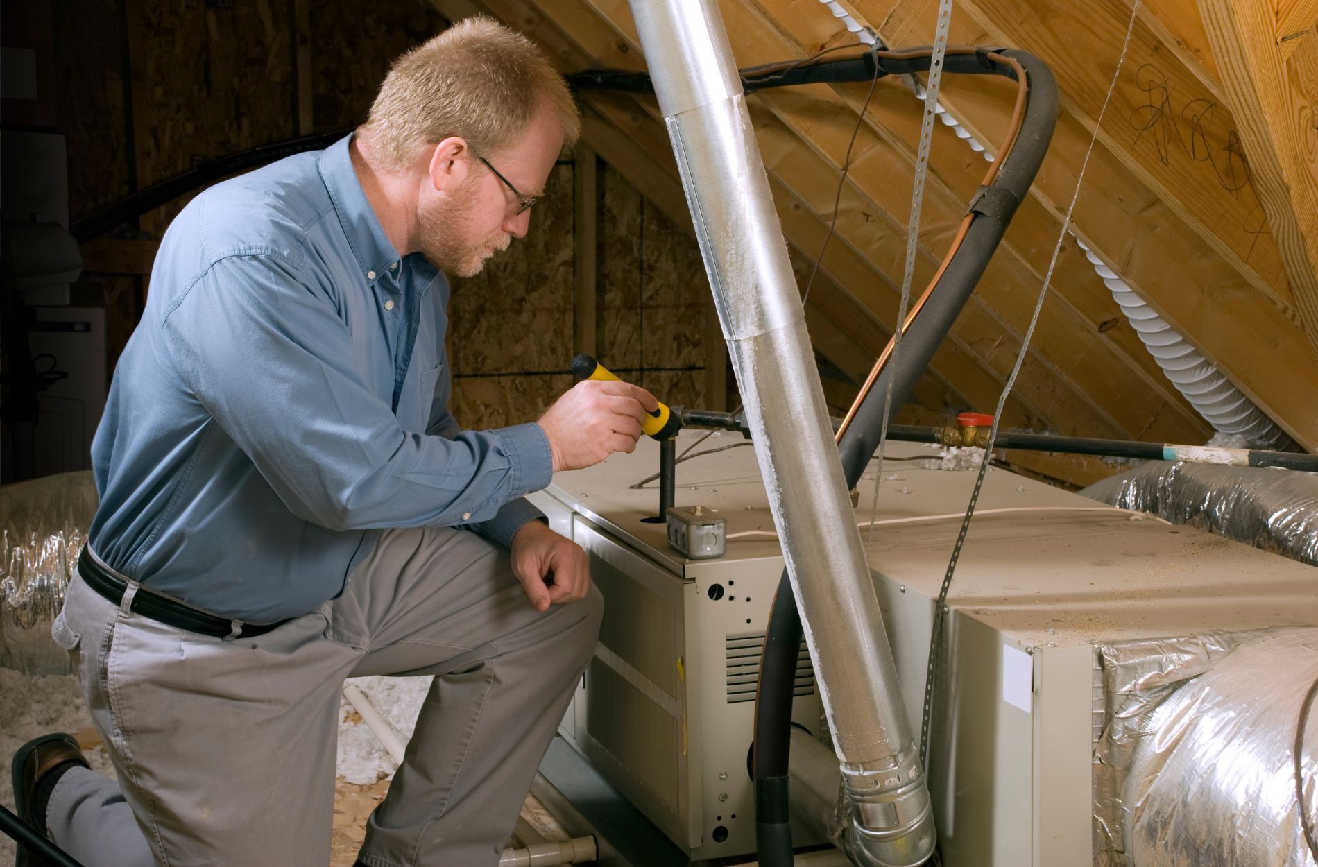 A technician working on a furnace unit