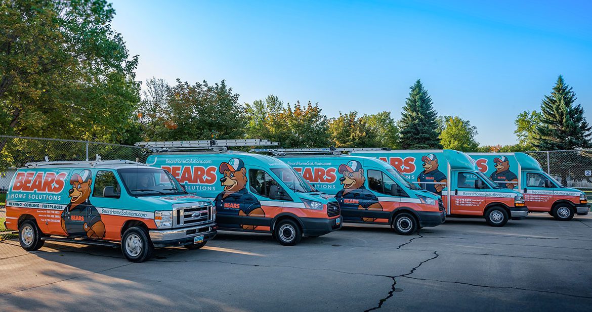 A fleet of five Bears Home Solutions HVAC service vans in a parking lot.