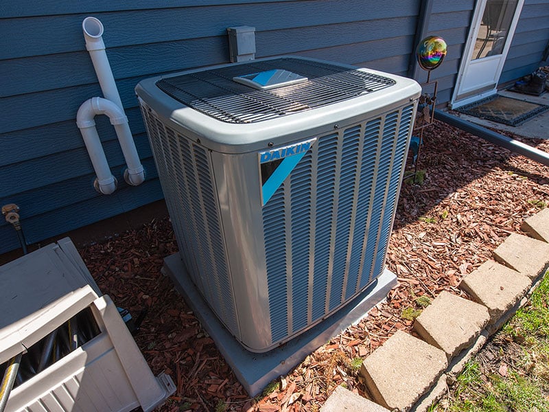A Daikin air conditioning unit outside a home