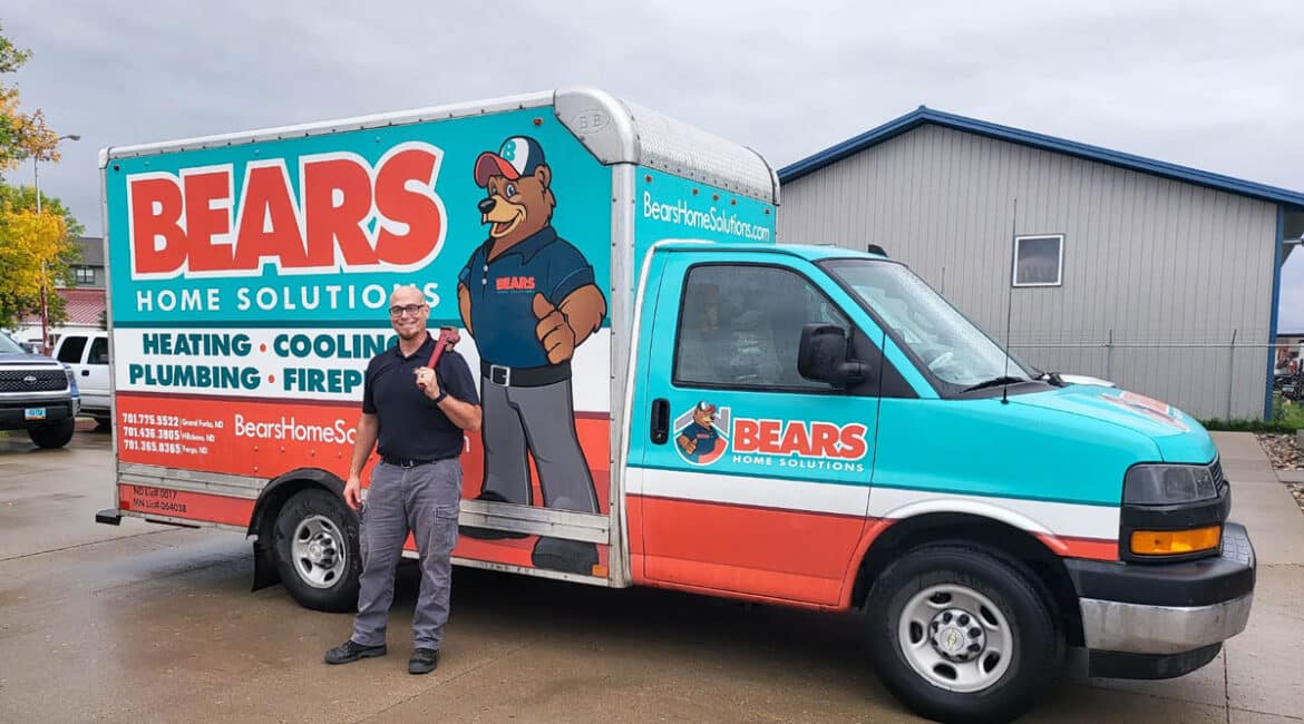 Plumber from Bears Home Solutions poses in front of his vehicle.