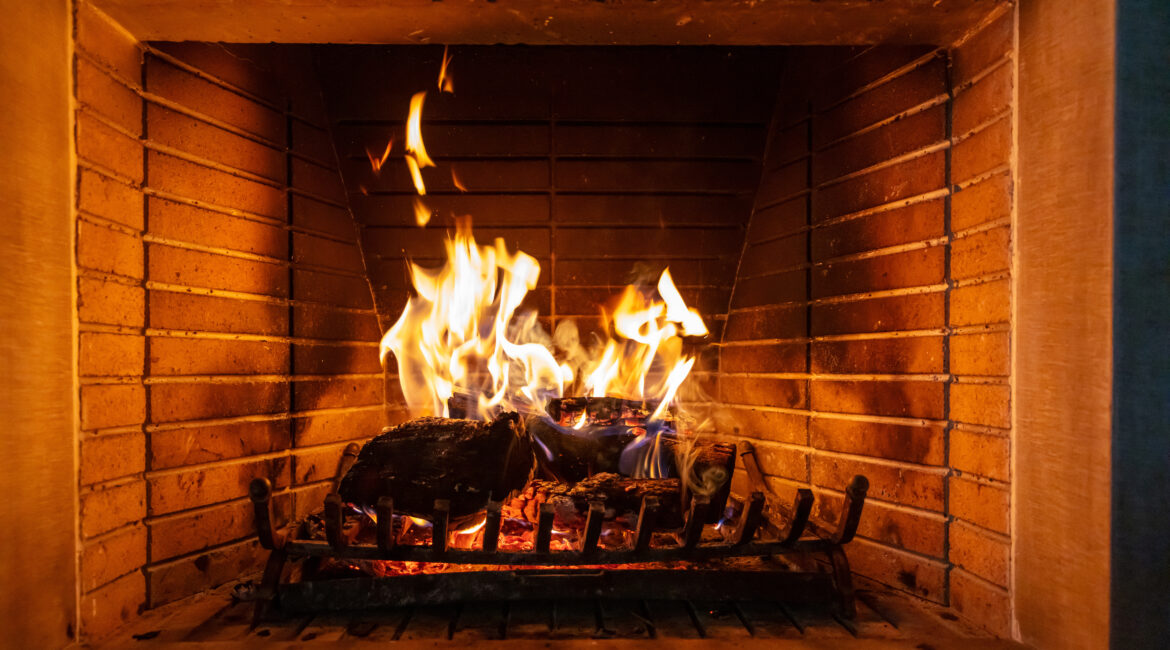 Christmas time Wood burning in a cozy fireplace at home