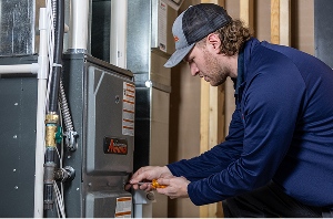 A technician working on a furnace unit
